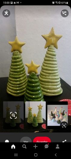 three small ceramic christmas trees sitting on top of a table