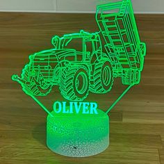 a green light that is shaped like a dump truck and has the word olver on it