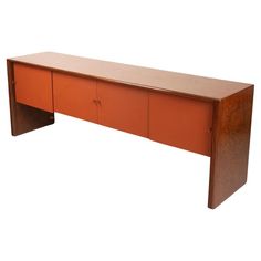 an orange wooden desk with two doors on one side and three drawers on the other