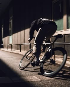 a man riding a bike down a street