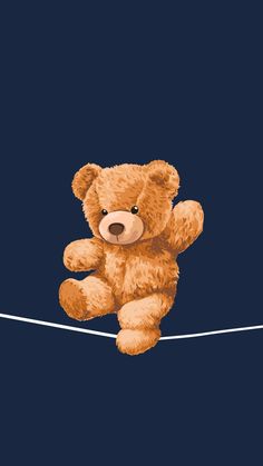 a brown teddy bear sitting on top of a rope