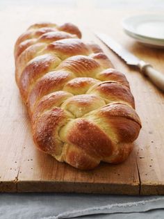 a loaf of bread sitting on top of a wooden cutting board