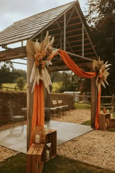 an outdoor wedding venue decorated with orange and white decor