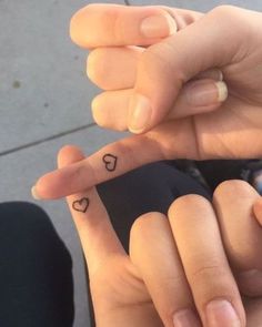 two fingers with small hearts on them