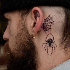 a man with a spider tattoo on his neck