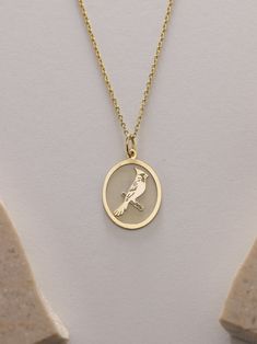 Gold Cardinal Bird Pendant - Bird Gold Necklace ● Material of pendant: Solid Gold 14k ( REAL GOLD ) ● Metal Stamp: 14k ( REAL GOLD ) ● The pendant is available in 5 sizes: - 12x17 mm / 0,47 x 0,66 inches - 13x18 mm / 0,51 x 0,70 inches  In the photos - 14x19 mm / 0,55 x 0,74 inches  - 16x21 mm / 0,62 x 0,82 inches  - 18x24 mm / 0,70 x 0,94 inches ( In the photos the size is 13x18 mm / 0,51 x 0,70 inches ) ( Jump Ring inner diameter: 4 mm ) ● Material of chain: Solid gold 14k ( REAL GOLD ) It is thin and dainty and it is available in 4 sizes: - 40 cm / 15,75 inches ( Length ) - 45 cm / 17,72 inches ( Length ) In the photos - 50 cm / 19,68 inches ( Length ) - 55 cm / 21,65 inches ( Length ) ● Backside engraving is FREE ( Please use the personalization box for that.) ● If you want larger size Gift Jewelry With Bird Design Round Pendant, Yellow Gold Bird Design Pendant Jewelry, Bird Design Round Pendant Jewelry As Gift, Round Pendant Jewelry With Bird Design For Gift, Bird Design Round Pendant Jewelry For Gifts, Bird Design Round Pendant Jewelry Gift, Gold Pendant Necklace With Bird Design, Necklace With Round Pendant And Bird Design For Gifts, Gold Bird-shaped Jewelry With Bird Design