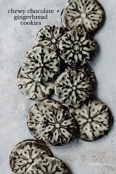 chocolate and gingerbread cookies with white glazes on a baking sheet, ready to be eaten