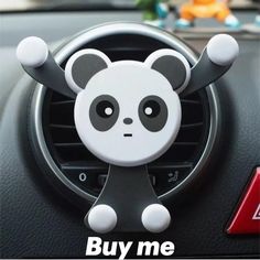 a panda bear steering wheel sticker with the words buy me on it's center console