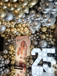 an assortment of silver and gold christmas ornaments hanging from the ceiling in front of a sign that reads 25 cents