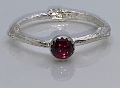 Sterling silver twig ring that is made from an olive tree twig that was shaped into a ring and then cast in sterling silver.  It has a 5mm Ruby gemstone.  The band is approximately 1.8 to 2mm due to the texture of the twig. It has a bright finish.  Occasion: birthday, wedding, anniversary, every day wear, etc Size 9 Twig Ring, Magical Jewelry, Classy Jewelry, Olive Tree, Ruby Gemstone, Stackable Rings, Cute Jewelry, Wedding Anniversary, Pretty People