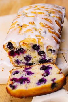 a loaf of blueberry bread sitting on top of a cutting board