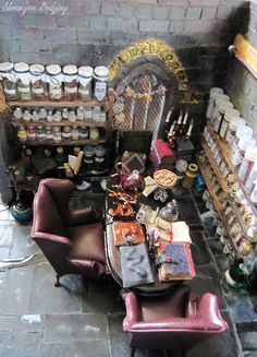 a living room filled with furniture and lots of clutter on the floor next to a brick wall