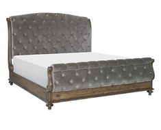 an upholstered bed with wooden frame and tufted headboard, made in grey velvet