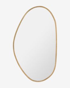 an oval shaped mirror with gold trim around the edges and bottom edge, on a white background