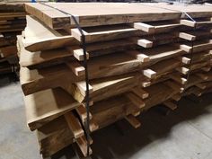 many pieces of wood are stacked on top of each other in a warehouse or workshop