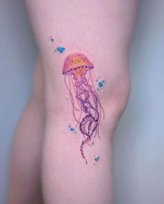 a small jellyfish tattoo on the leg