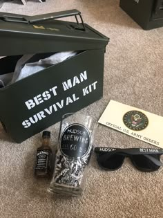 the best man survival kit is on the floor next to his sunglasses and other items