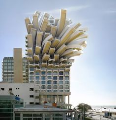 an unusual building that looks like it's floating in the air with many windows