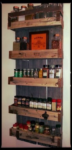 a wooden shelf filled with lots of spices