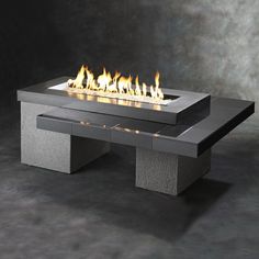 an outdoor fire table with flames on it