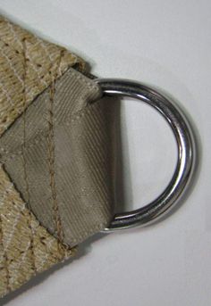 a close up of a keychain with a metal ring attached to it's side