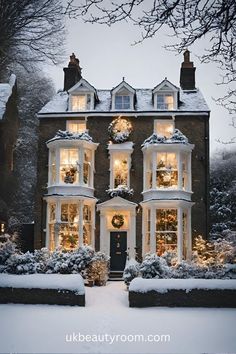 a large house covered in snow with christmas lights