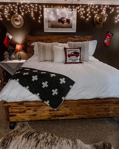 a bedroom decorated for christmas with lights on the wall and bed in the middle,