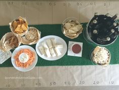 a table topped with plates and bowls filled with food on top of a green mat