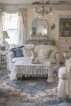 a living room filled with furniture and a chandelier hanging from the ceiling in front of a window