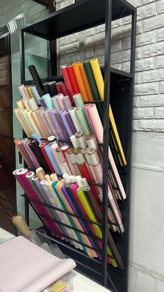 there is a rack with many different colored items in it