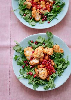 two plates filled with food on top of a table