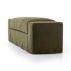 a large green ottoman sitting on top of a white floor