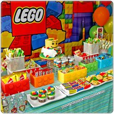 a lego themed birthday party complete with cupcakes, cake and candy buffet table