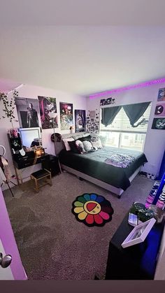 a bedroom with purple walls and pictures on the wall