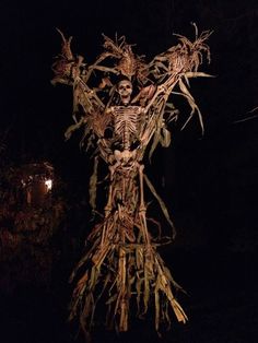 a scarecrow is standing in the dark