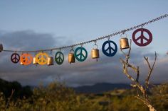 peace signs and bells hanging from a chain