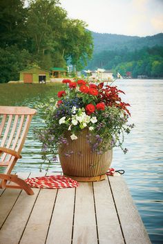 a flower pot sitting on top of a wooden dock