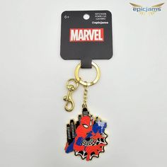 a spiderman keychain is hanging on a white surface with a black tag attached to it