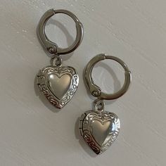 Silver Heart Locket Earrings - Etsy Heart Locket Earrings, Silver Handmade Earrings, Dangle Heart Earrings, Heart Charm Metal Earrings For Gift, Metal Dangle Heart Earrings With Heart Charm, Heart-shaped Surgical Steel Jewelry For Gifts, Silver Vintage Earrings, Silver Stainless Steel Hoop Earrings As Gift, Nickel-free Metal Heart Earrings As Gift