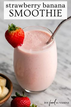 a strawberry banana smoothie in a glass with a spoon