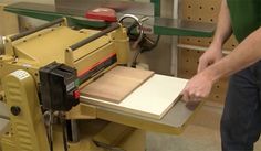 a man is using a table saw to cut wood