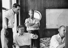 black and white photograph of three men in a living room