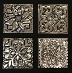 four square metal tiles with designs on them, all in different shapes and sizes to choose from