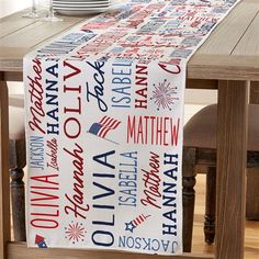 a patriotic table runner with red, white and blue lettering on the top is sitting on a dining room table