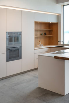 a modern kitchen with an oven and sink