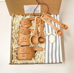 wooden spoons and measuring spoons in a box with labels on the handles,