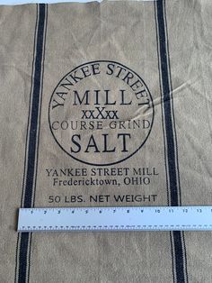 a bag with a measuring tape on top of it that says yankee street mill course grind salt