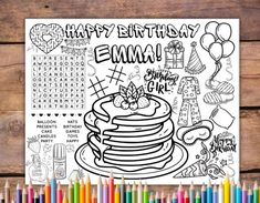 happy birthday coloring page with lots of colored pencils and markers on a wooden table