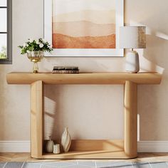 a wooden table with vases and books on it in front of a wall mounted painting