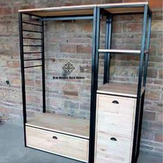 an open closet with drawers and shelves in front of a brick wall